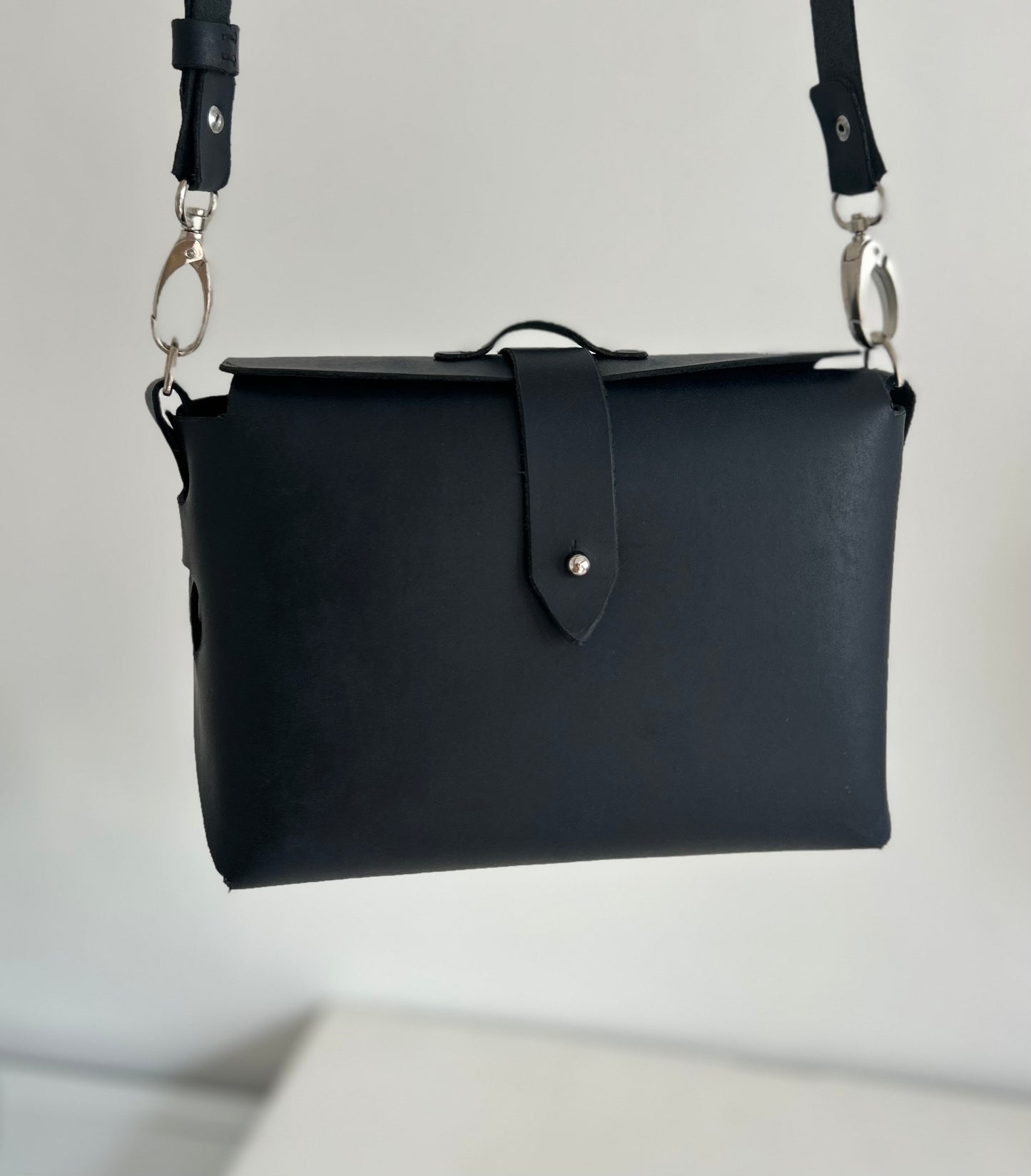 Dark ink leather bag with leather strap