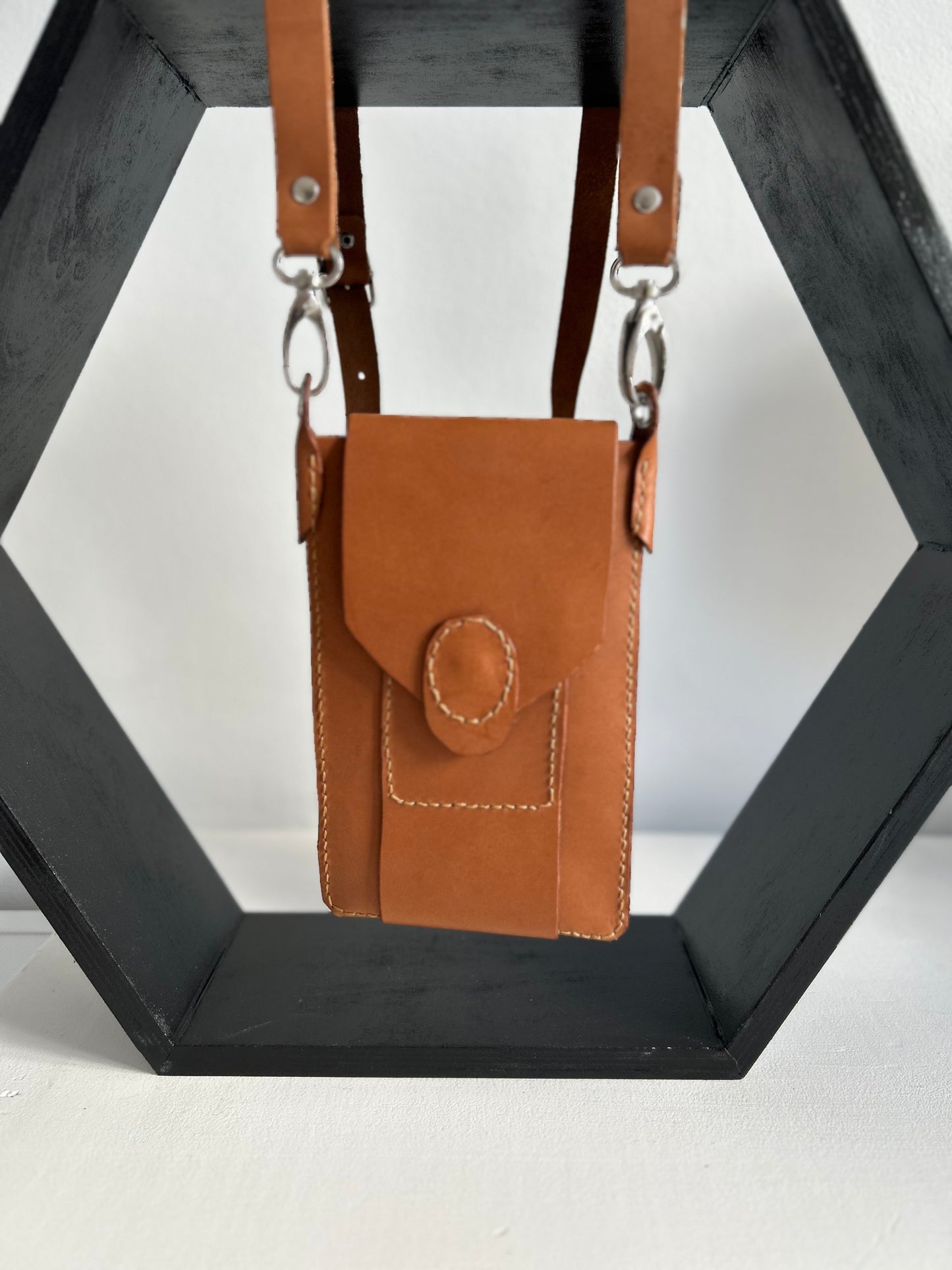 Light tan leather handbag suitable for holding a phone, one card and few smaller items.