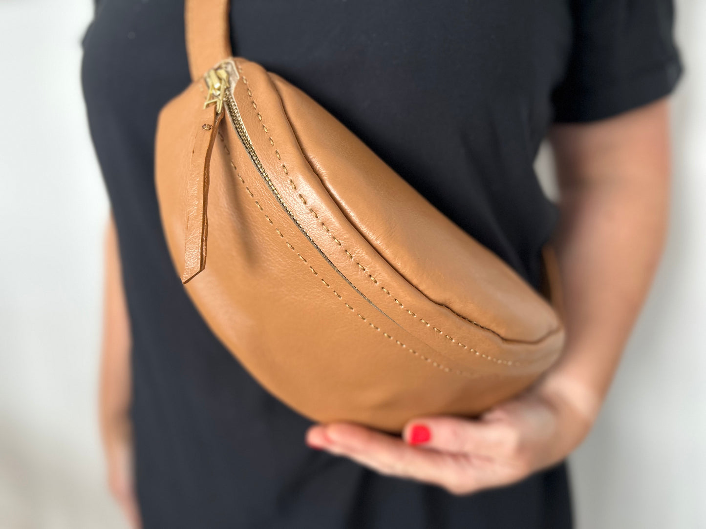 Light tan leather moon bag with adjustable strap