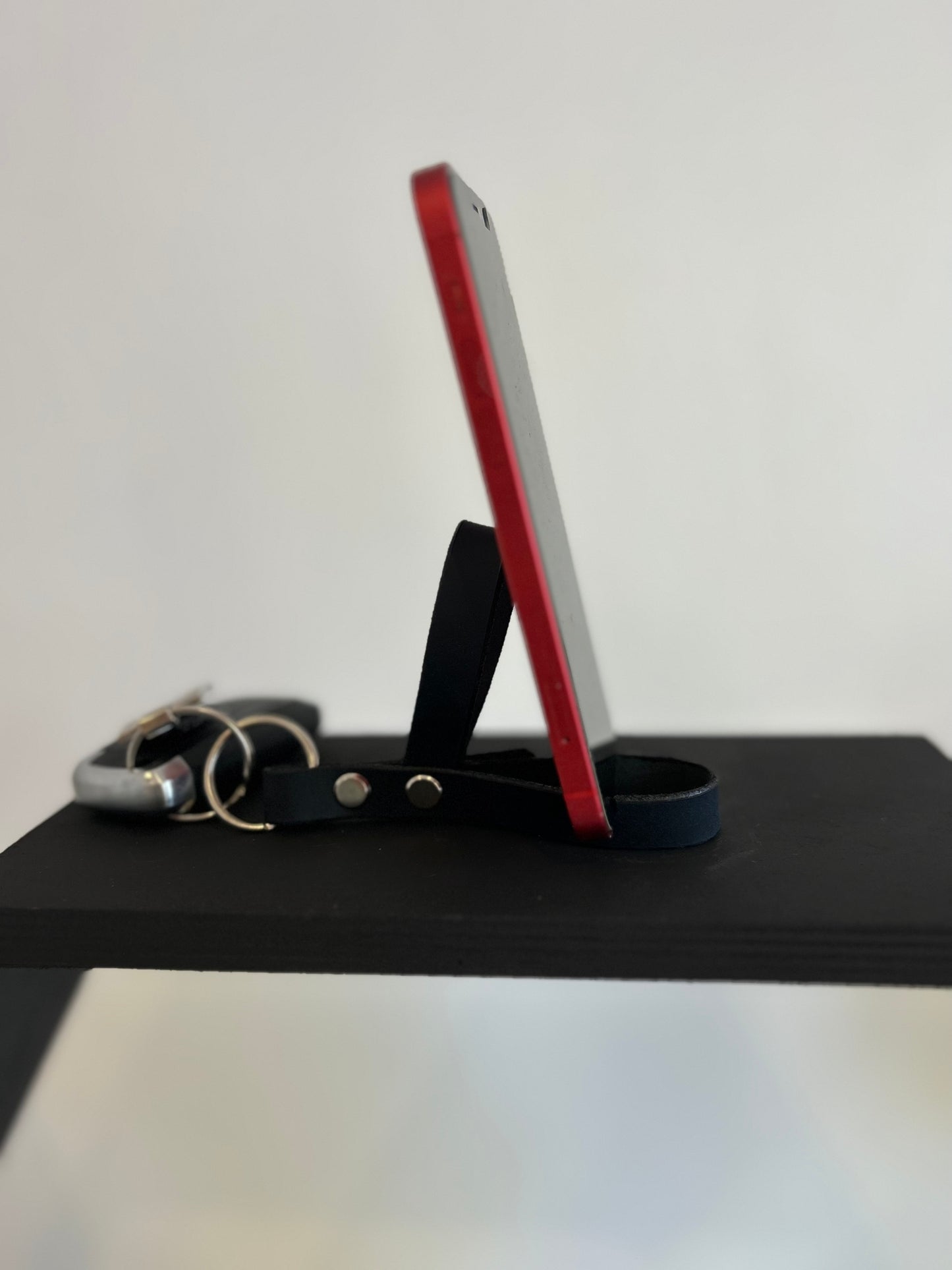 Leather key ring that can extend to prop up a phone. Useful for watching videos/making video calls.