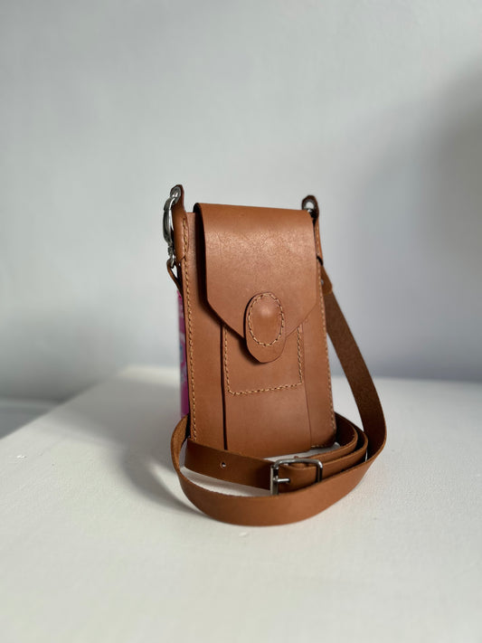 Light tan leather handbag suitable for holding a phone, one card and few smaller items. 