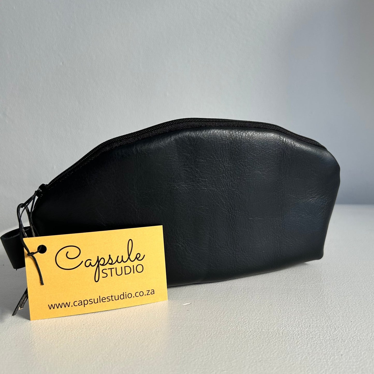 Black leather pouch with zipper and water-resistant lining