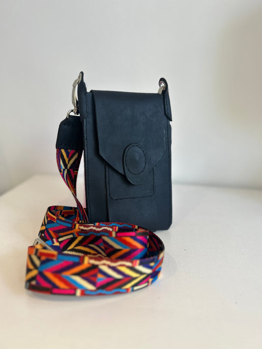 Genuine leather hand-stitched phone bag with bright  coloured geometric webbing strap.  