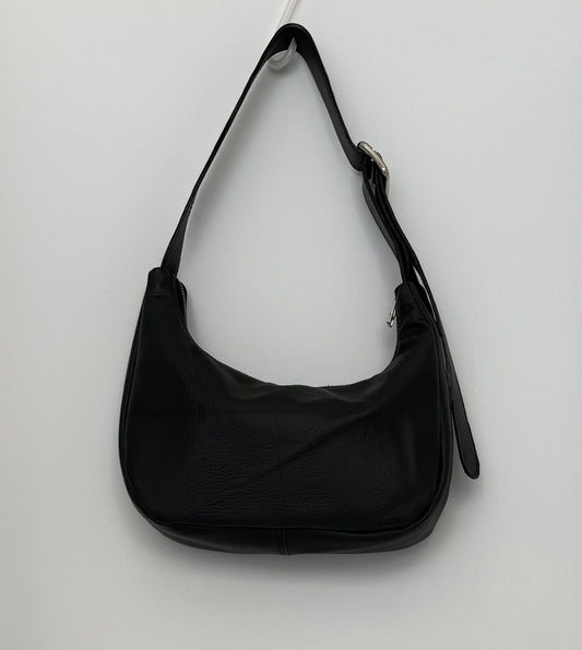 Black leather handbag with chrome zip and slider on a white background