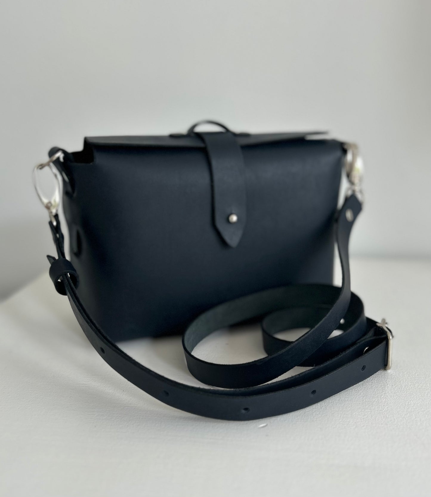 Dark ink leather bag with leather strap