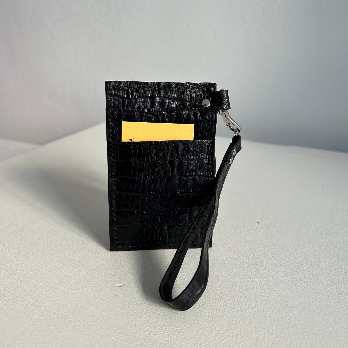 Black leather card and cash wallet with hand strap