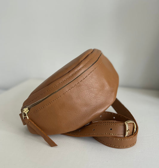 Light tan leather moon bag with adjustable strap