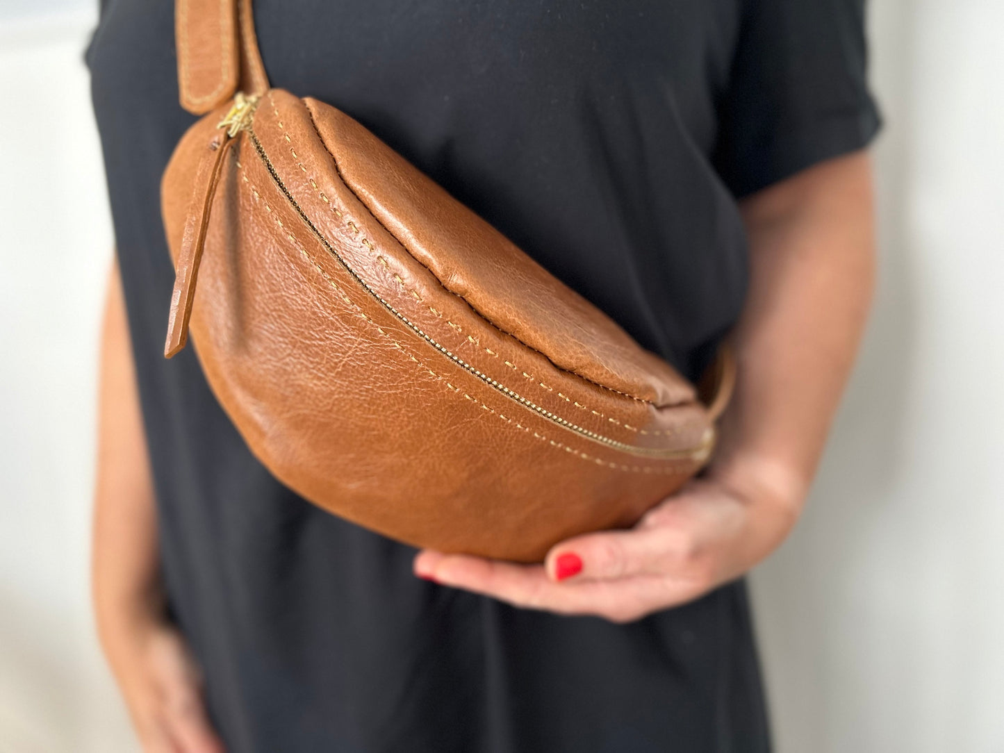 Dark tan leather moon bag with adjustable strap